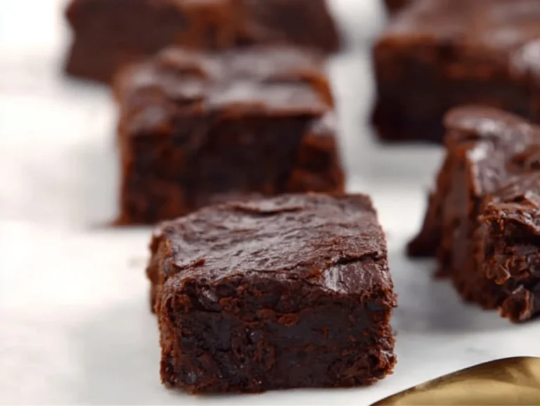 A plate of sugar free brownies with apples displayed on a table