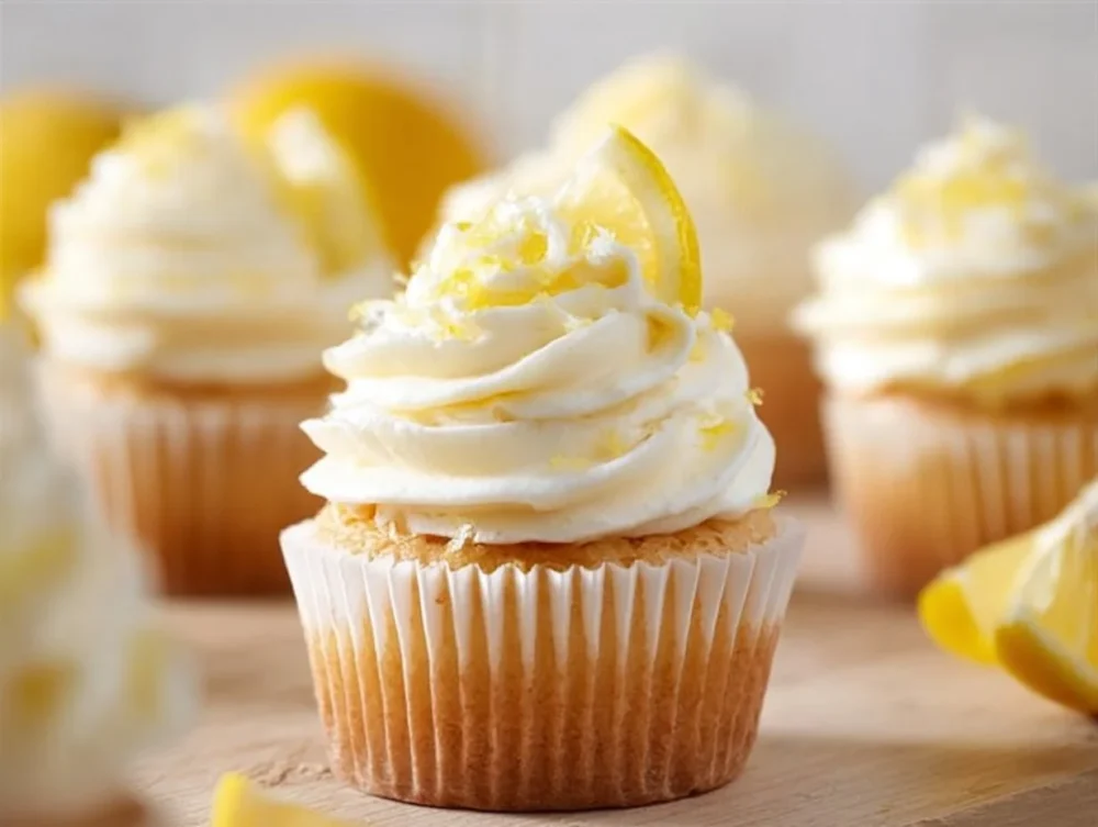Delicious zesty lemon cupcakes decorated with lemon icing and fresh zest